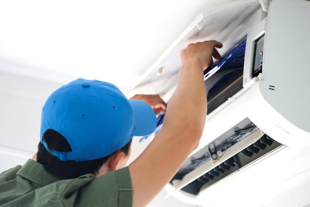 Technician servicing a ductless mini split AC unit. Air conditioning maintenance in Cheverly, Maryland for optimal performance.