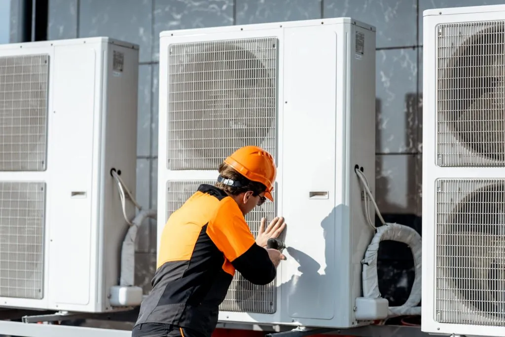 HVAC technician repairing an air conditioning unit in Cheverly, Maryland. AC repair and maintenance by certified professionals. Expert service.