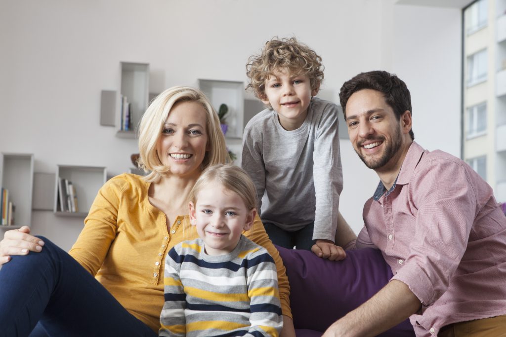 Happy family portrait in Cheverly, Maryland. Mother, father, son, and daughter smiling, showcasing family togetherness in Prince George's County.