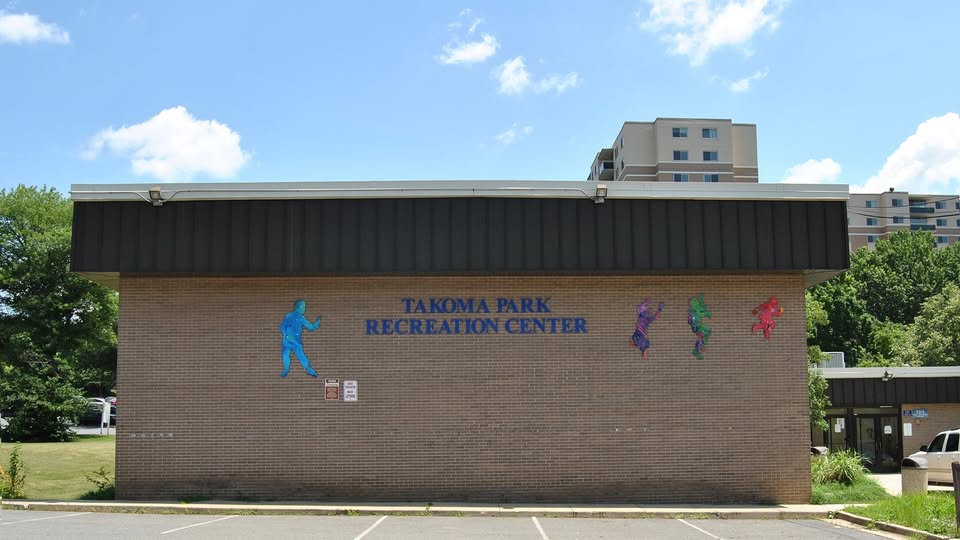 Takoma Park Recreation Center building facade with colorful sports figures painted on the brick. Community hub in Takoma Park, Maryland.