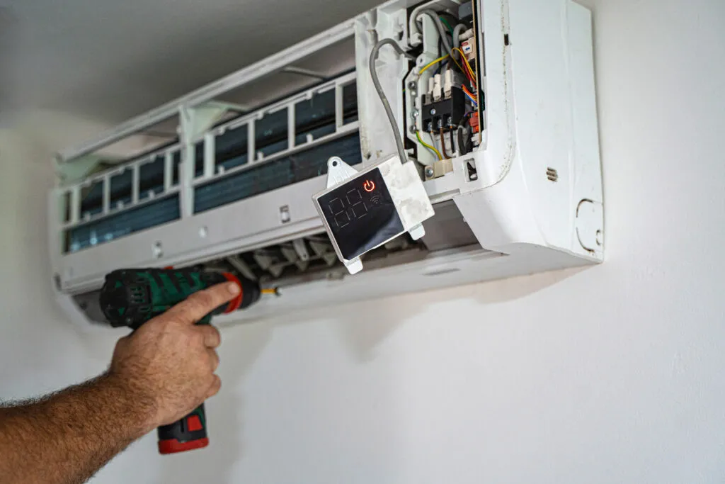 Ductless Mini Split Installation: Technician installing a mini split system. Get expert ductless air conditioning services in Cheverly, Maryland.